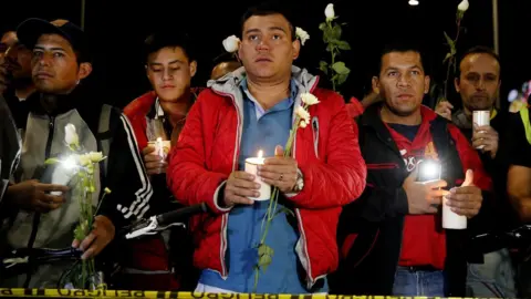 EPA Citizens and police hold candles during a vigil at the Francisco de Paula Santander General Police Cadet School in Bogota