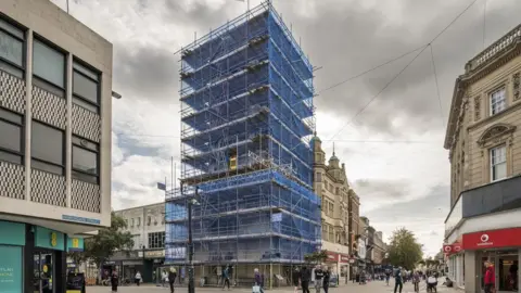 Historic England Tower of the former Church of St Michael covered in scaffolding