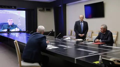 AFP via Getty Images In this group photo released by Russia's state news agency Sputnik, Russian Defense Minister Andrei Belousov (2nd L) and Federal Security Service (FSB) director Alexander Bortnikov (3rd L) along with Secretary of the Russian Security Council Sergei Shoigu listen as Chief of the General Staff of the Armed Forces of the Russian Federation Valery Gerasimov (L) is seen on a screen as he remotely participates in a meeting with heads of law enforcement agencies to resolve the situation in the Kursk region, in Moscow, on August 7, 2024.