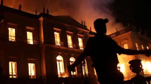 Reuters A policeman clears the area during a fire at the National Museum of Brazil in Rio de Janeiro, Brazil on 2 September2018.