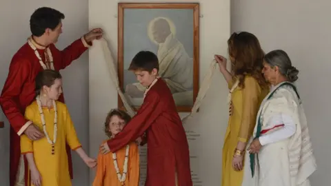 Getty Images Xavier Trudeau arranging Hadrien for a photo