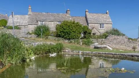 BBC Houses and a pond in Worth Matravers