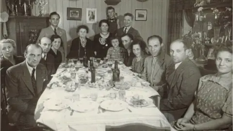 Elsie's sister Esther (fourth from right), who died at Auschwitz, attending a dinner with Jewish friends in June 1942. Only five people in this group survived the Holocaust