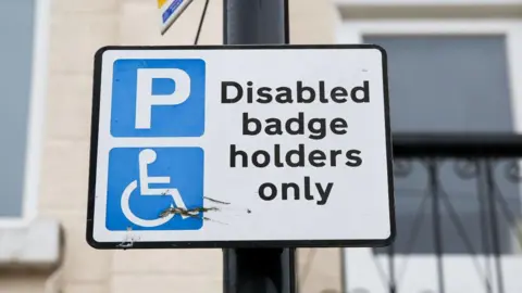 Getty Images Disabled badge holders only parking sign