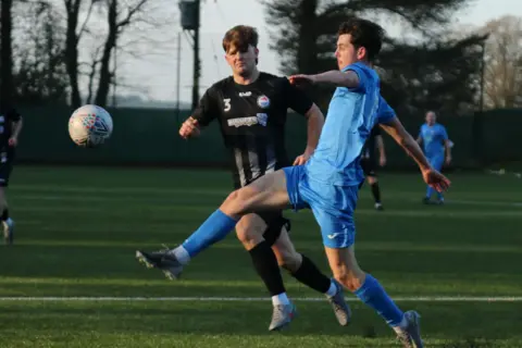 Dalbeattie Star FC Two young footballers battle for the ball - one is in a light blue kit and the other in black