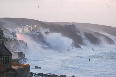 PA Media Waves hits Porthleven on the Cornish coast as Storm Eunice makes landfall on 18 February 2022