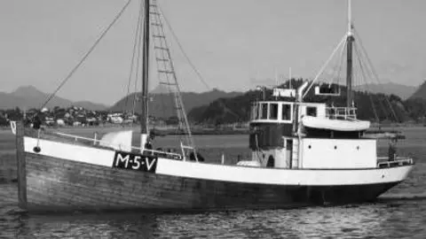 The Liberation Convoy A black and white image of a small-to-medium sized boat on the water. It has "M5V" written on the side of it.