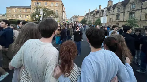 Crowds in the street of Oxford taking photos