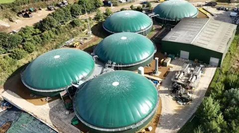 Severn Trent Green Power A bird's eye view of the site from September. All the tanks have been repaired. They have green roofs. It's sunny.