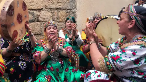 Reuters Women in traditional costume perform during a music festival in Ath Bouada, Algeria - Saturday 26 June 2021