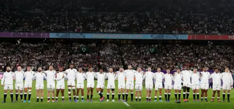 Getty Images The England starting players and replacements singing the national anthem before the semi-final against New Zealand