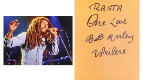 Dawsons On the right is a picture of Bob Marley singing at a mic stand. On the right, is a yellow sheet of paper with the words "One Love, Bob Marley, Wailers" written