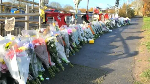 BBC Floral tributes near Nova Hroed Academy in Swindon