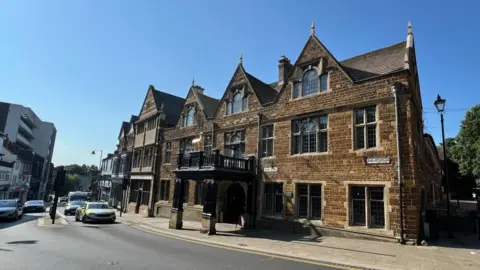 Steve Hubbard/BBC 16th Century stone-built three storey hotel on road junction