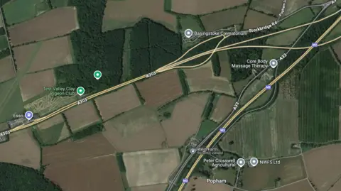 A map of the north of Hampshire. Yellow lines show the roads A303 and M3. There are brown, green and light green patches showing farm land. 