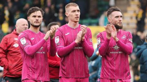 Liam Cullen, Jay Fulton and Matt Grimes applaud Swansea's fans after their draw at Norwich in April