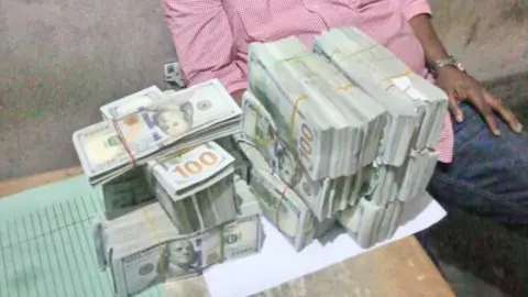 Rivers State Police Command Dollar bills stacked up