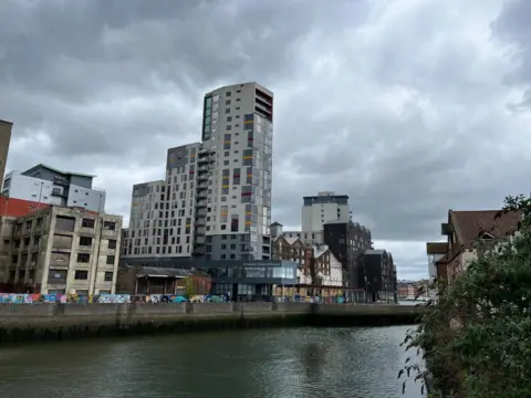 Shaun Whitmore/BBC The Mill towers over other waterfront buildings in Ipswich 