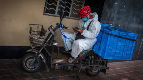 BBC Delivery rider on the streets of Shanghai