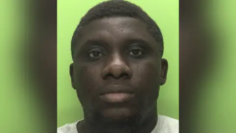 Nottinghamshire Police A mugshot of Adedapo Adegbola, a 40-year-old Black man.