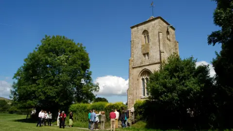 A line of people queueing up to get into a church