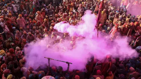 Getty Images Revellers celebrate Lathmar Holi, the Hindu spring festival of colours, in Nandgaon near Mathura on February 26, 2026.