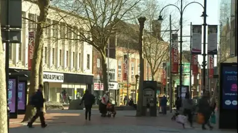 Broad Street in Reading - a pedestrianised area with several people walking along the road