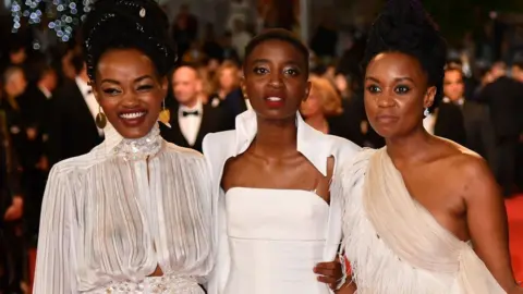 Getty Images Sheila Munyiva and Samantha Mugatsia with director Wanuri Kahiu