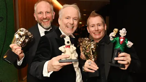 Getty Images Richard Beek, Nick Park and Merlin Crossingham, winner of Best Animated Film for "Wallace and Gromit: Vengeance Most Fowl", pose backstage during the EE BAFTA Film Awards 2025 at The Royal Festival Hall on February 16, 2025 in London, England