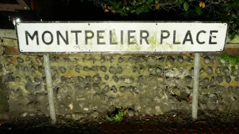 Eddie Mitchell Street sign reads 'Montpelier Place'