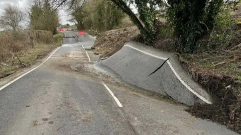 A road wih surface splits and rising parts