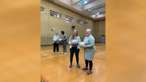 Bristol After Stroke Four people talking in pairs and holding netballs