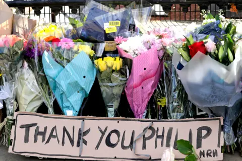 Getty Images Floral tributes are seen at Buckingham Palace