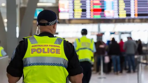 Getty Images An Australian Federal Police officer at Sydney Airport