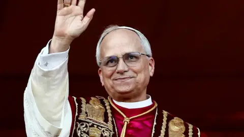 Pope Leo XIV waving at the crowd