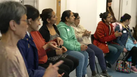 Women sitting in a semi-circle