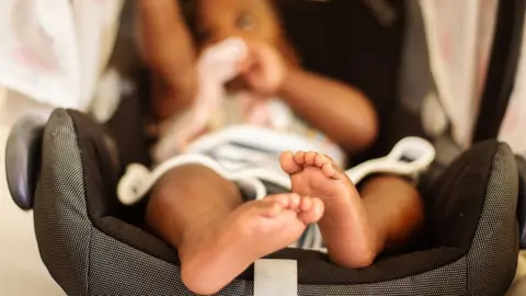 Newborn in travel seat