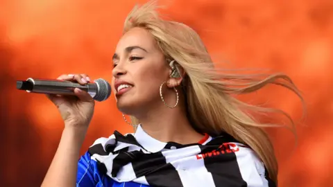 Getty Images Jorja Smith sings while on stage at a festival