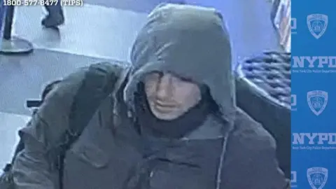 Reuters CCTV image showing man wearing hooded jacket with backpack slung over his right shoulder