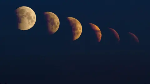 The image is blacked out except for the phases of the Moon, from left to right it is getting more and more out of vision, covered by shadow and deepening in colour starting from a cream shade and ending as a burnt orange colour.