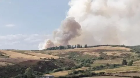 A fire seen on a hill