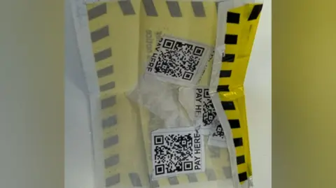 Coventry City Council A yellow and black label with three QR codes on the reverse side. The QR codes say "PAY HERE" in capital letters at the bottom.