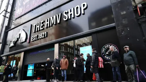 PA Media People queue outside the flagship store of HMV on Oxford Street