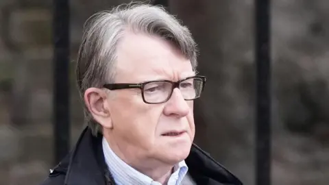 PA Media Lord Peter Mandelson outside his home in north west London following his arrest on suspicion of misconduct in public office.