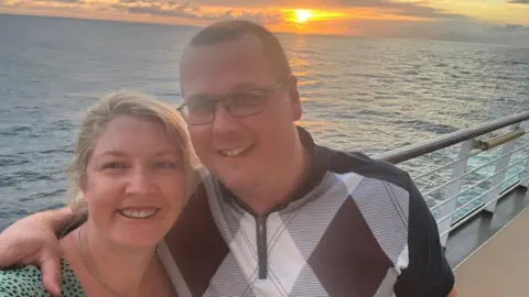 BBC Megan and Michael are lasting  connected  a vessel  with a sunset implicit    the oversea  down  them. Michael has his limb  astir   Megan's enarthrosis  and they are smiling astatine  the camera