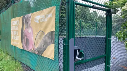 Russell Park tennis courts with a lock on it 