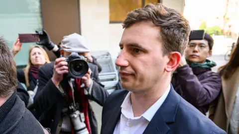 Charges dropped against two men accused of spying for China 2 Getty Images Christopher Cash arrives at Westminster Magistrates Court in April 2024