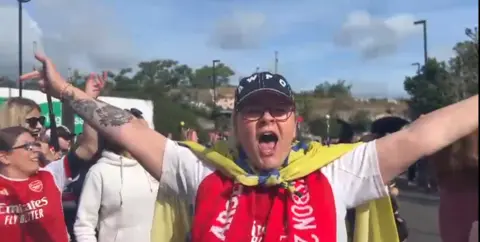 Kate Sheard holding her arms out and cheering 