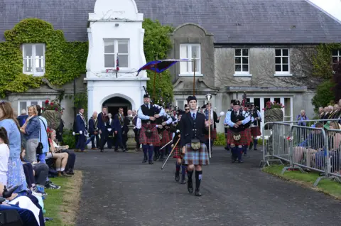 Pacemaker Tens of thousands of visitors converged on the charming Co Down village for the traditional celebrations, which seen a parade of 4,000 members of the Royal Black Institution and around 70 bands.