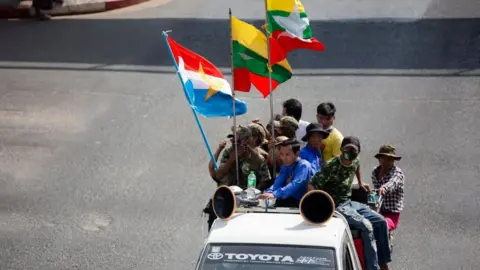 Getty Images Military supporters drive along the Streets in Yangon.